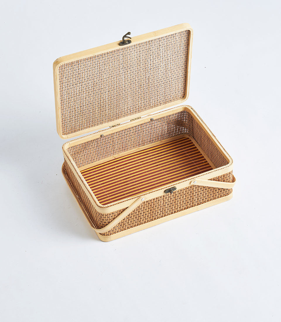Light woven rattan rectangular gift basket with hinged lid and striped interior lining