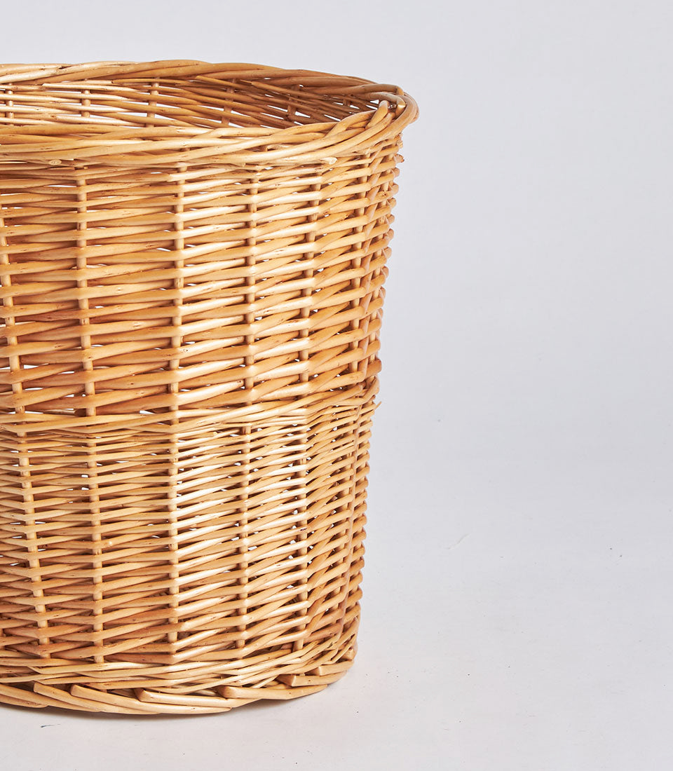 Handwoven natural wicker storage basket with light brown tan weave and cylindrical shape