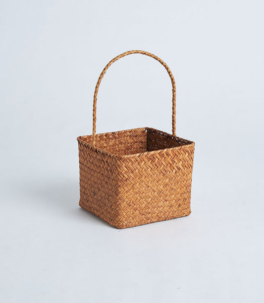 Natural brown woven square basket with curved handle, ready for gift filling