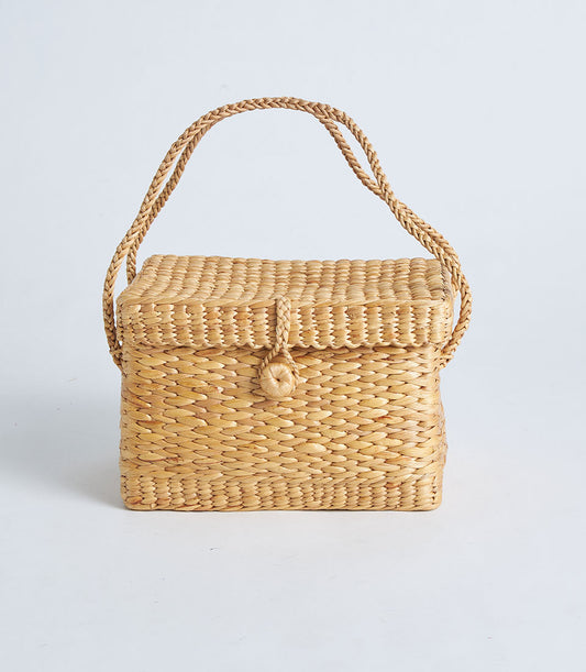 Natural woven straw basket with braided handle and scalloped lid closure