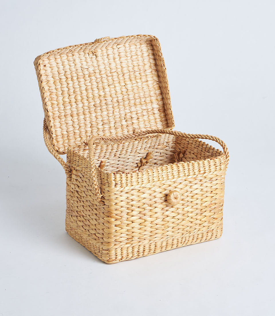 Handwoven natural straw basket with braided trim, handle and secure lid for luxury gift storage