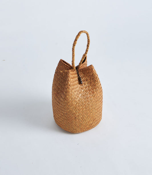 Natural straw gift basket with rope handle and red tassel detail