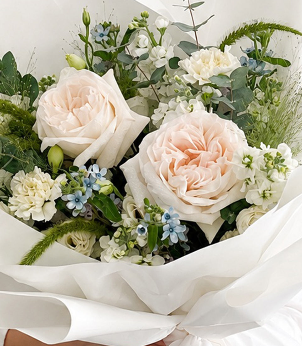 An elegant premium flower bouquet from Flowers by Basketeer featuring blush garden roses, white