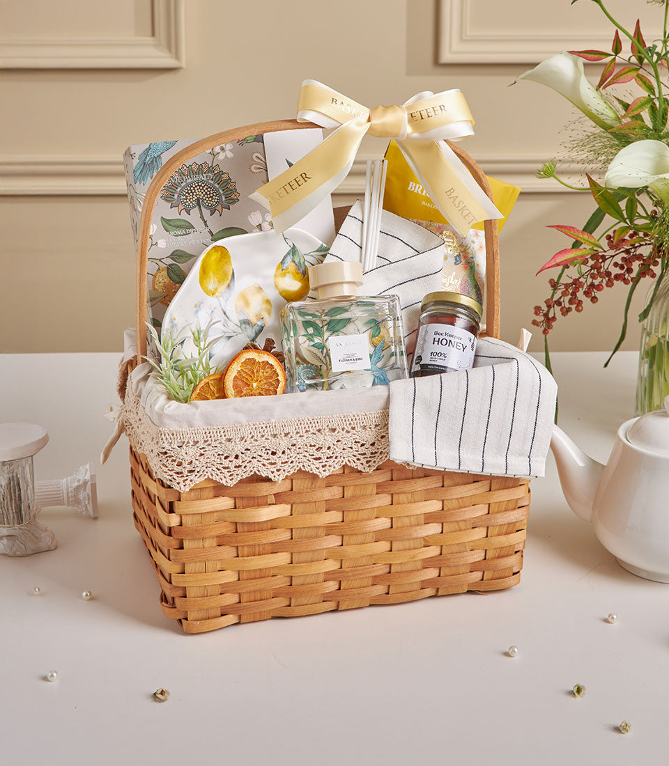 Lemon Grove wicker gift basket with honey, dried citrus, aromatherapy diffuser, and wellness essentials