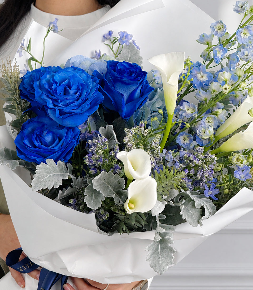 Royal blue roses and white calla lilies bouquet with delphiniums