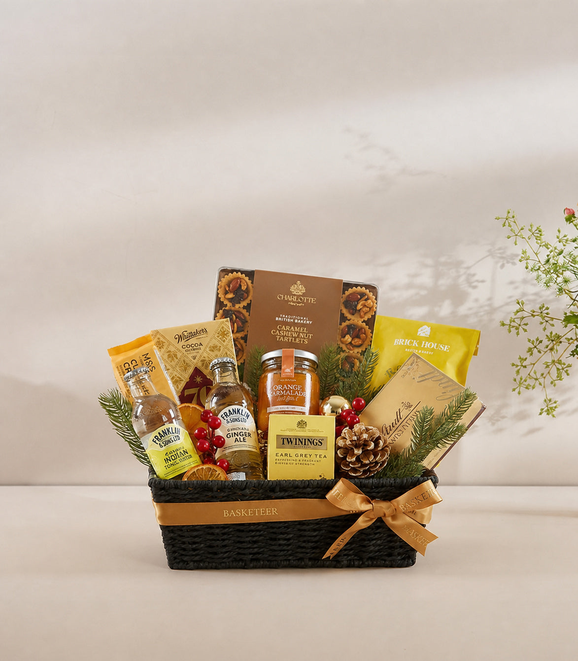 Basketeer luxury gourmet gift hamper in a black woven basket with gold ribbon
