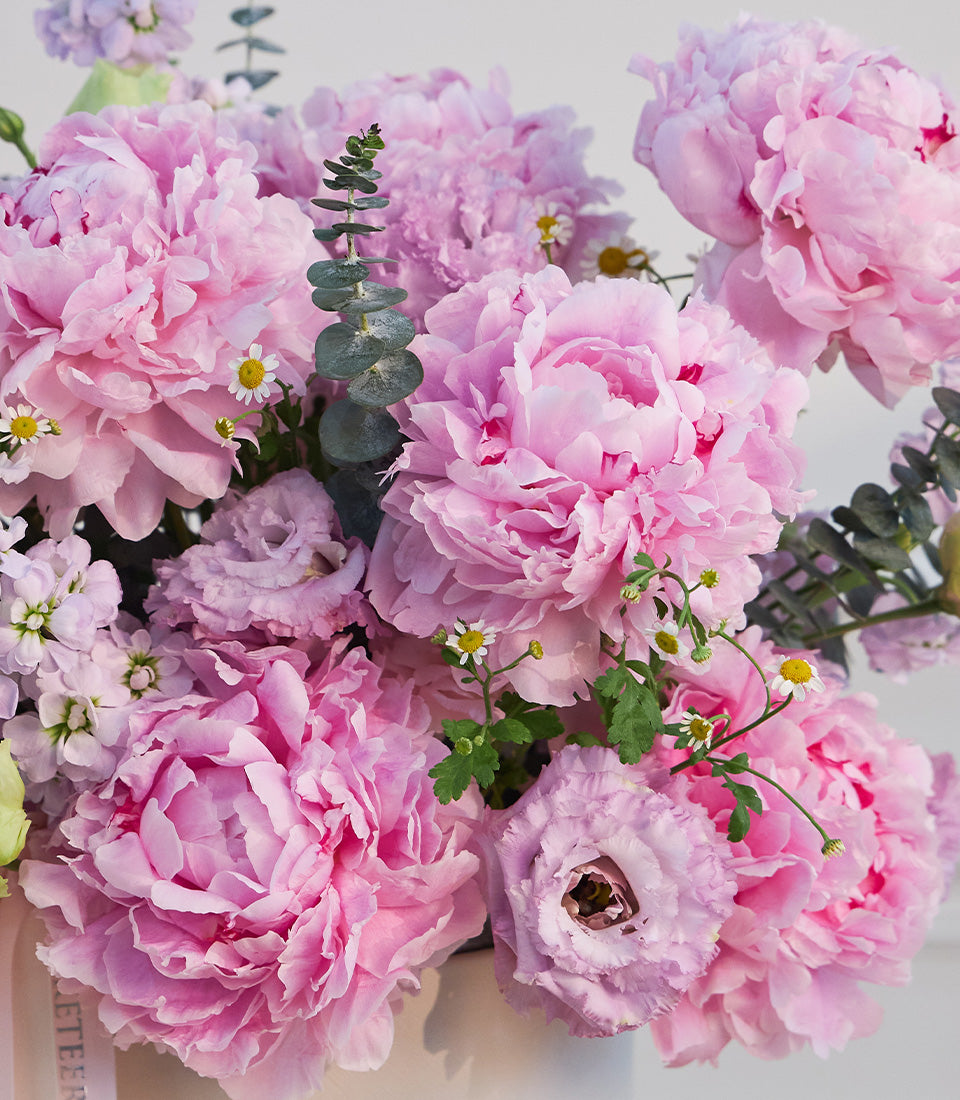 Lush pink peony and mixed flower arrangement in a premium white box, accented with
