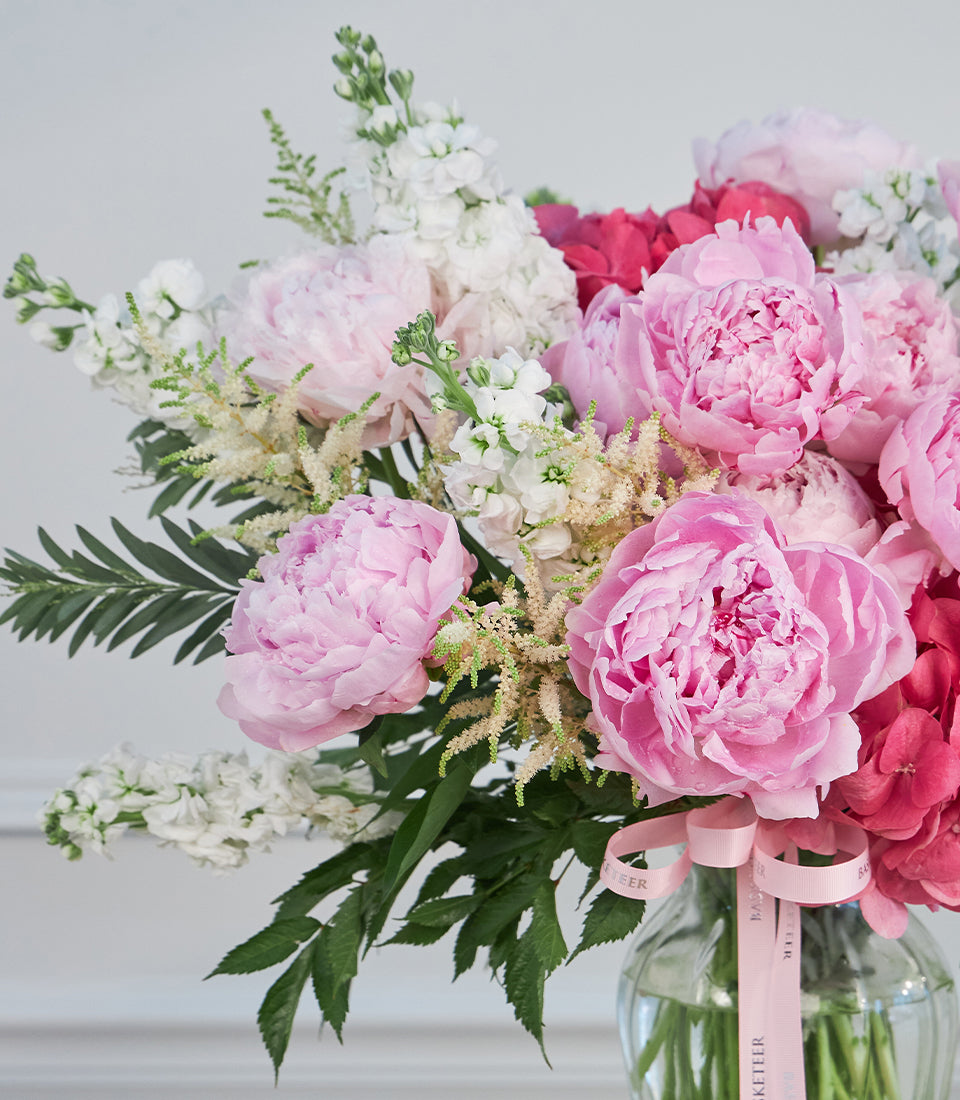 Lush pink peony and white stock flower arrangement with feathery astilbe and