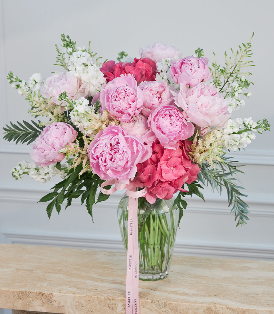 Lush premium flower arrangement for flower delivery Bangkok, featuring vibrant pink peonies, hyd