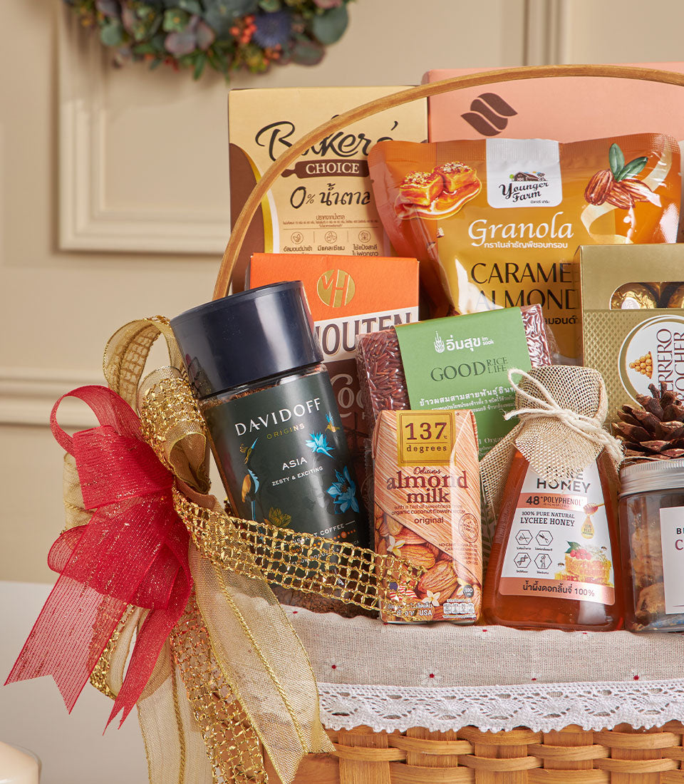 Premium New Year gift hamper with almond crackers, chocolate treats, lychee honey, and gourmet selection in woven basket