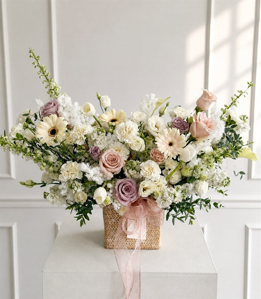 Elegant flower basket arrangement by Flowers by Basketeer, featuring premium blush pink and lavender