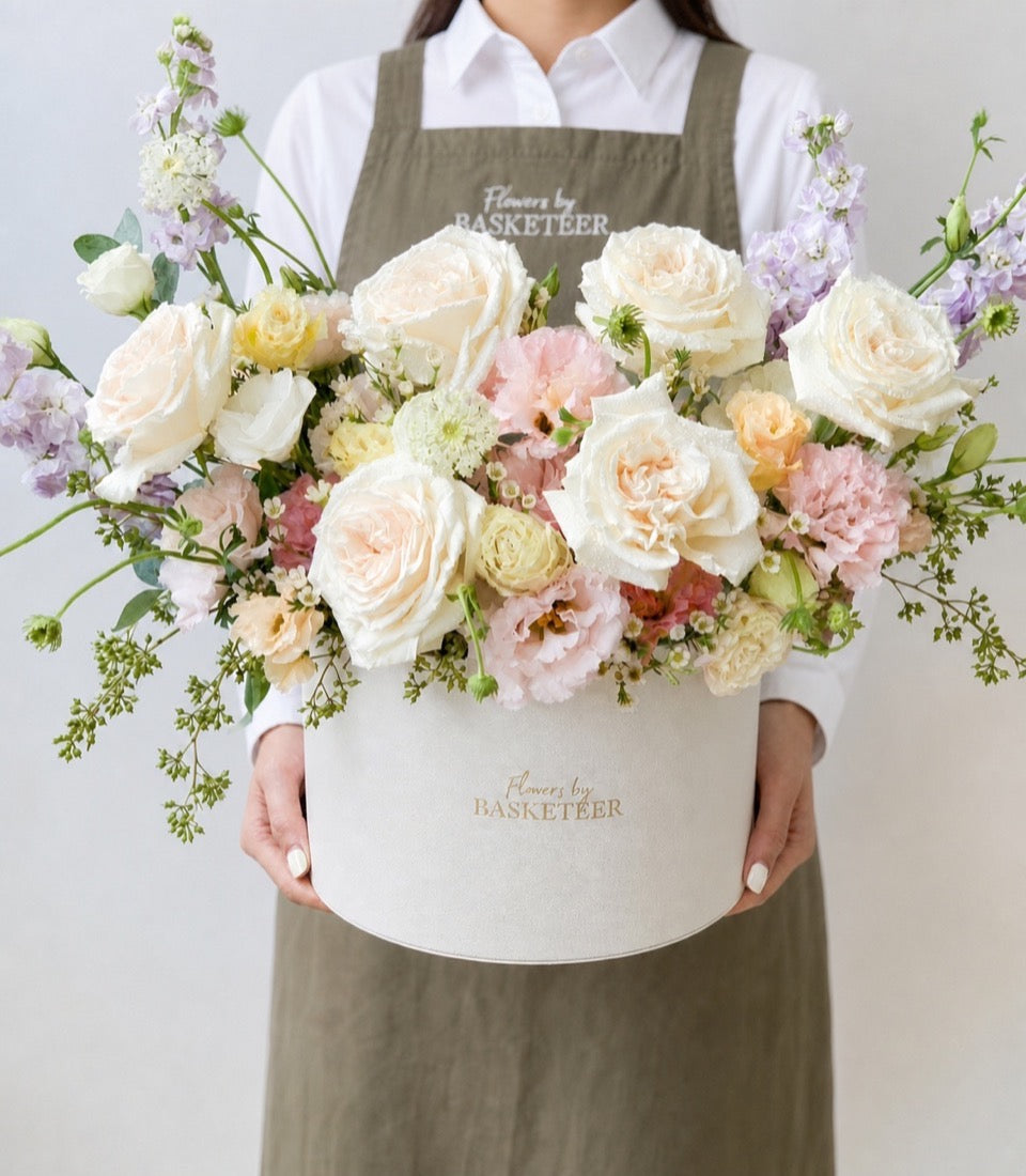 A luxurious flower box arrangement from Flowers by Basketeer featuring blush roses