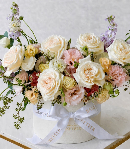 A premium flower box arrangement from Flowers by Basketeer, featuring delicate pastel roses