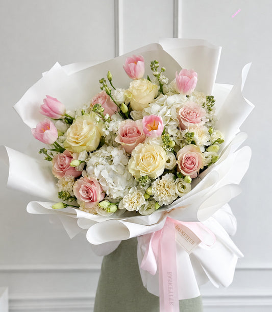 Luxurious Basketeer flower gift with pink tulips, cream and pink roses, and