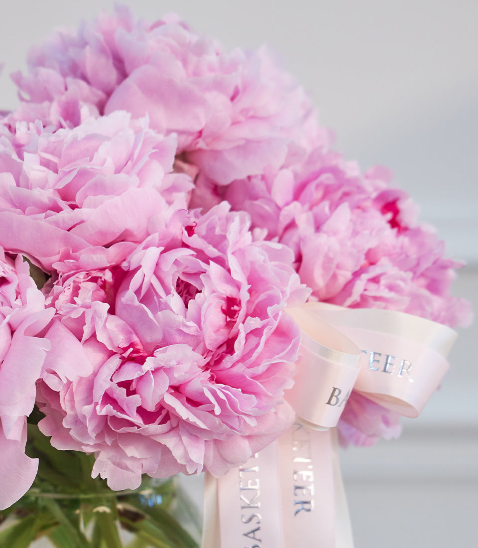Lush pink peony vase arrangement by Flowers by Basketeer, tied with an