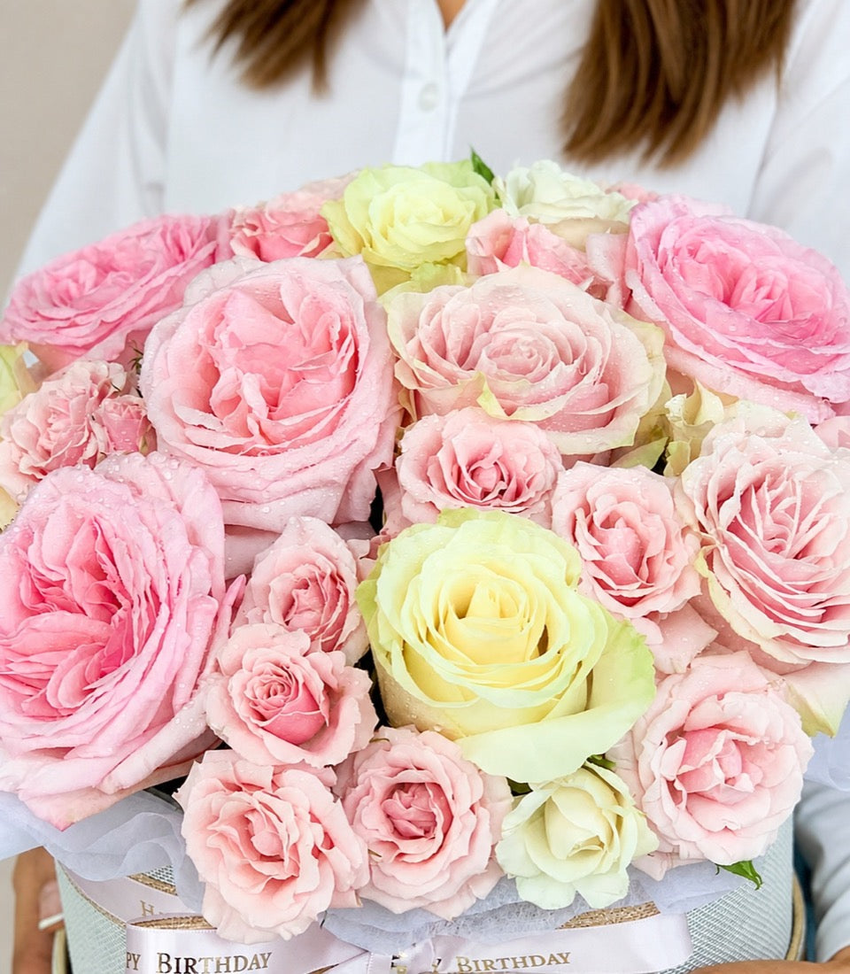 A luxurious flower box arrangement from Flowers by Basketeer featuring lush pink and creamy
