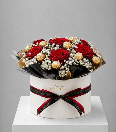 Elegant flower box arrangement featuring vibrant red roses, delicate white baby's