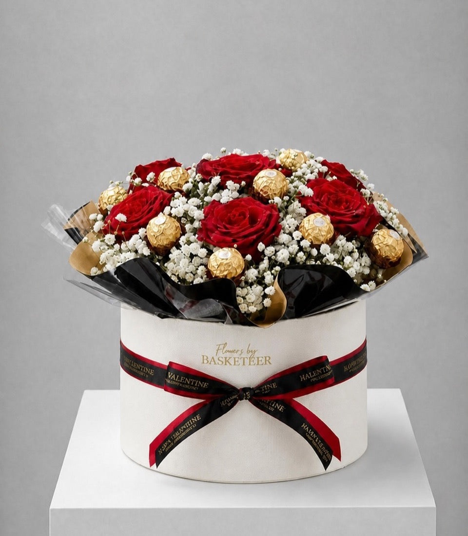 Elegant flower box arrangement featuring vibrant red roses, delicate white baby's