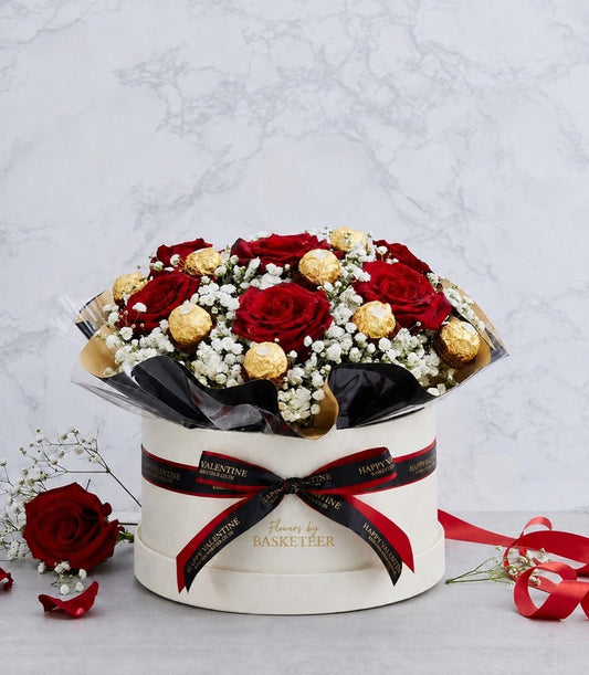 Elegant arrangement of deep red roses, white baby's breath, and gold Ferr