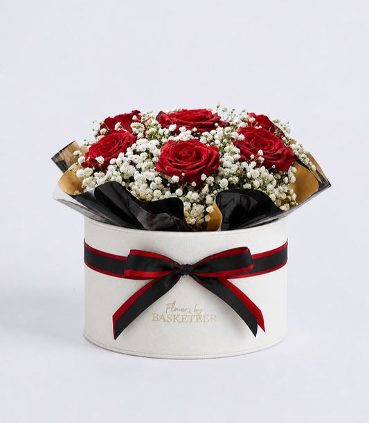 Luxurious flower box from Flowers by Basketeer featuring six vibrant red roses and