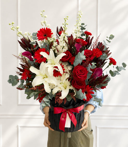 Luxurious flower box arrangement from Flowers by Basketeer featuring vibrant red roses