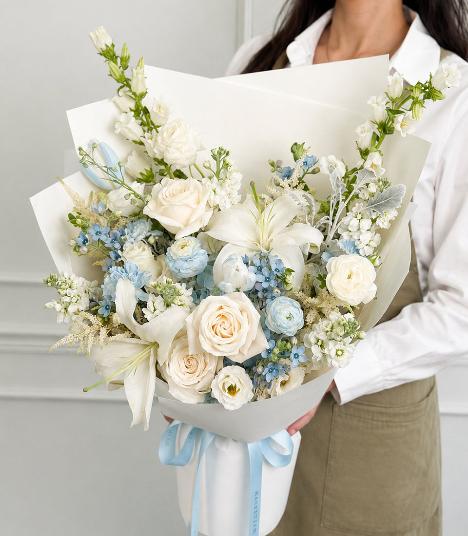 White rose, lily and tulip bouquet with pale blue hydrangea