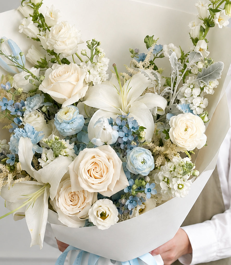 White rose, lily and tulip bouquet with pale blue hydrangea