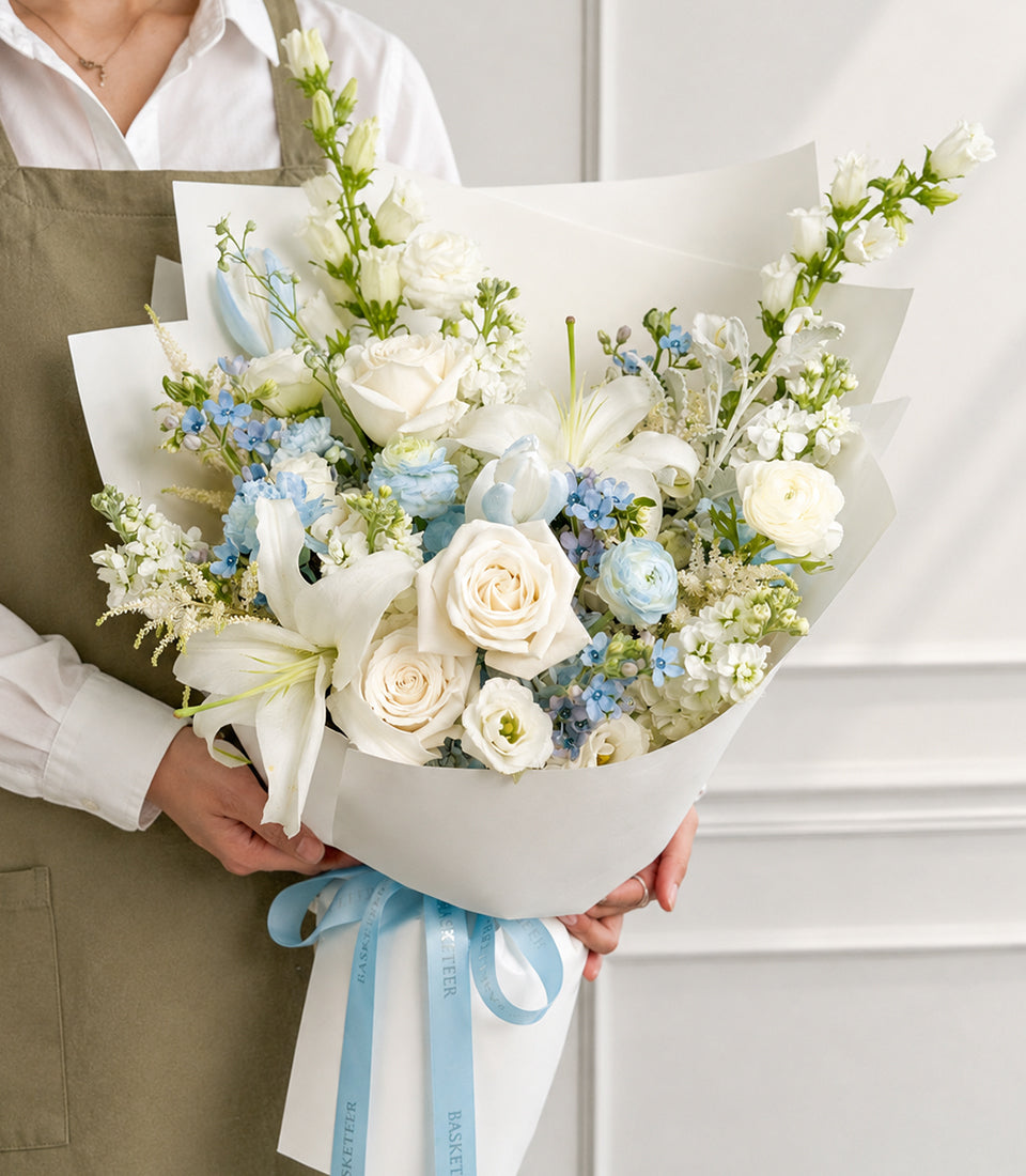 White rose, lily and tulip bouquet with pale blue hydrangea