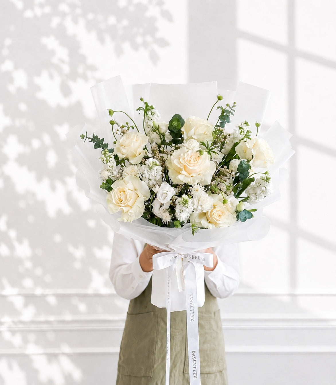Elegant white rose bouquet by Flowers by Basketeer, featuring cream garden roses, stock