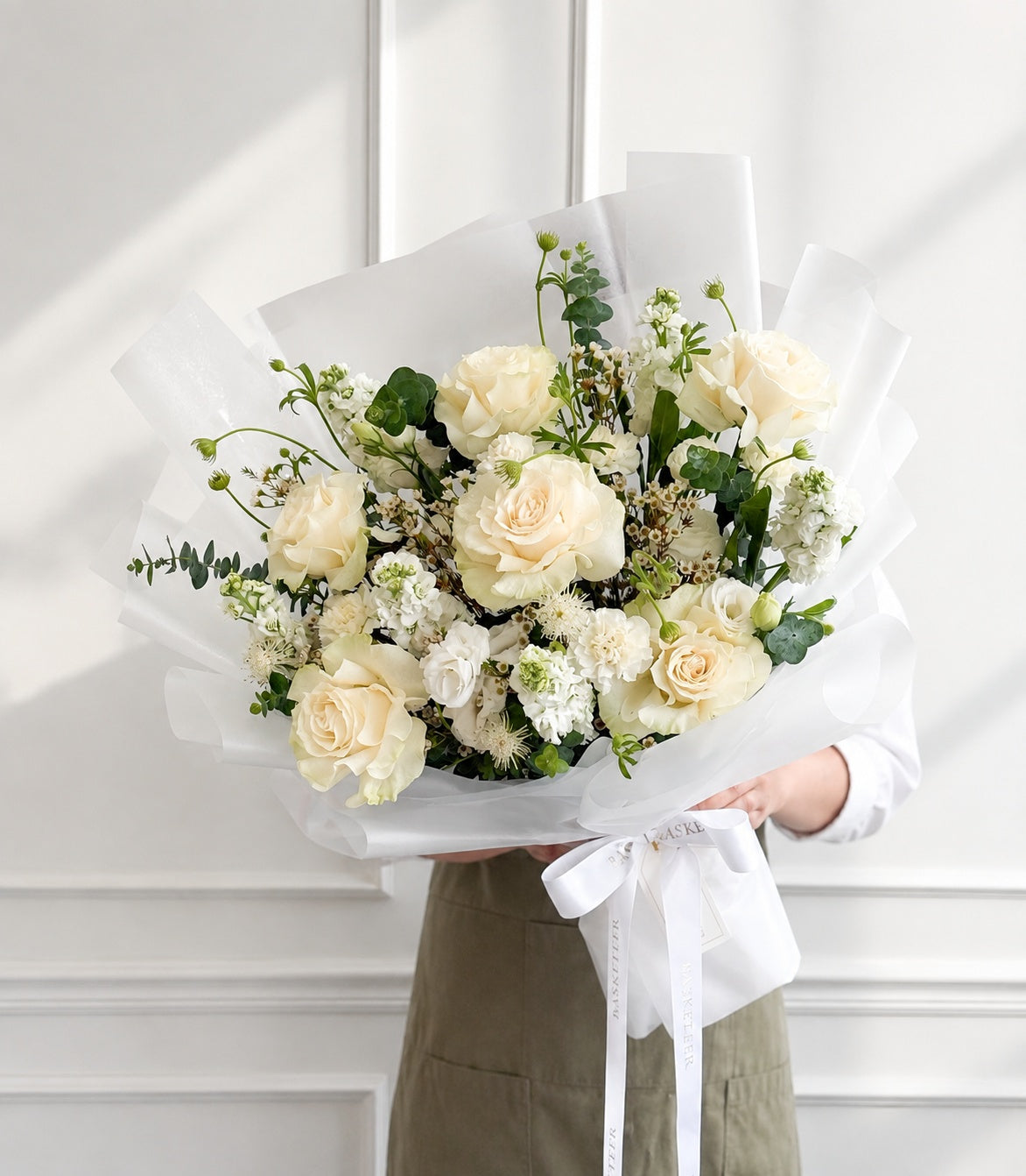 Elegant white rose bouquet by Flowers by Basketeer, featuring lush cream roses, delicate