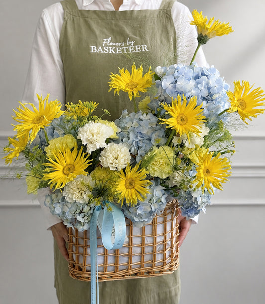 Basketeer's vibrant luxury flower gift basket with bright yellow gerber
