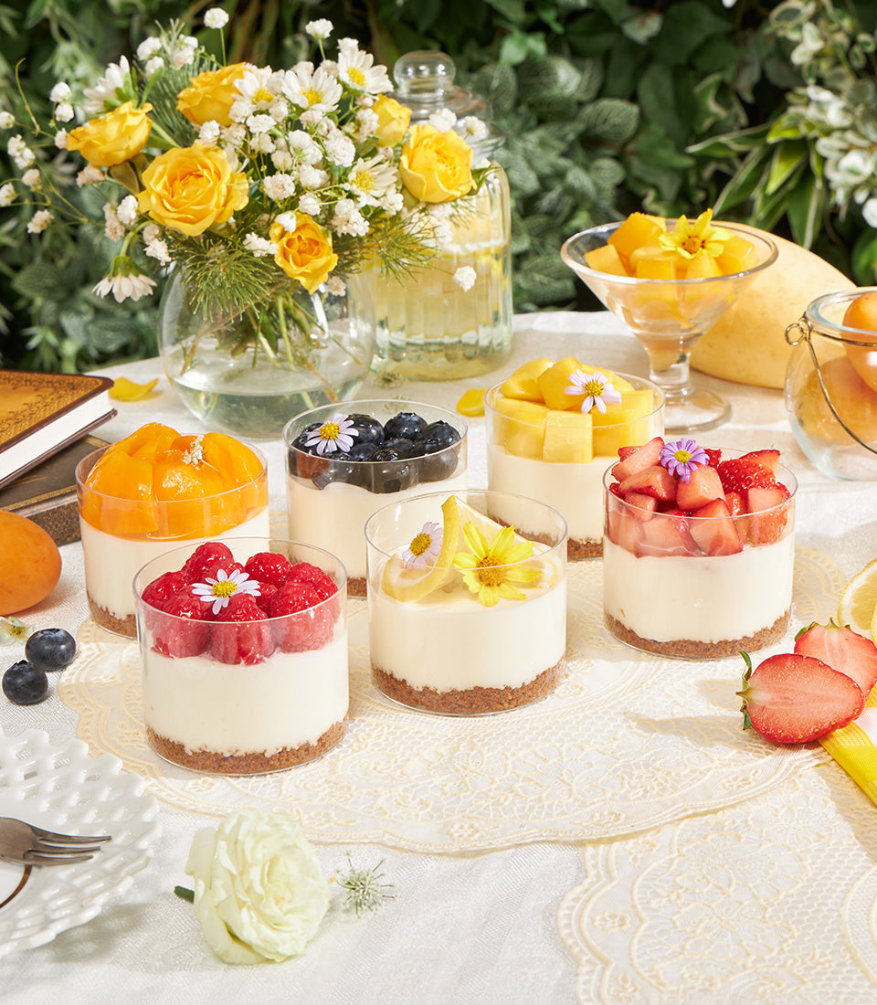 Mini Biscoff cheesecake cups with assorted fresh fruit toppings and edible flowers