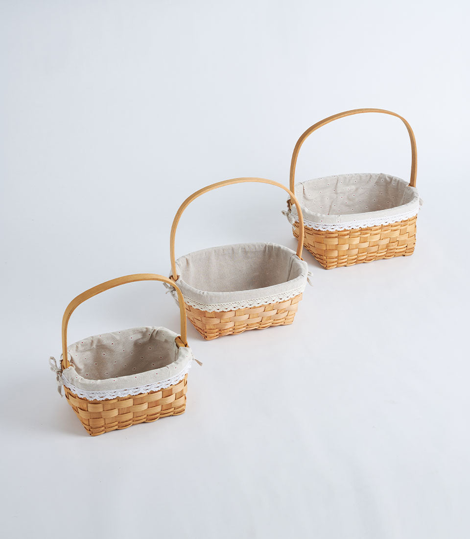 Three sizes of Basketeer premium handwoven wicker baskets with elegant fabric liners and lace