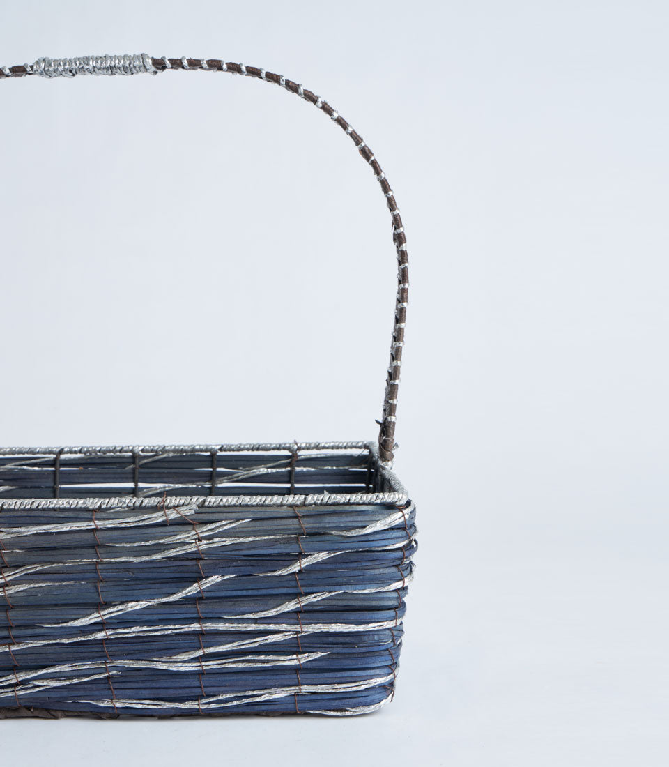 Dark blue woven gift basket with silver accents and metal frame handle