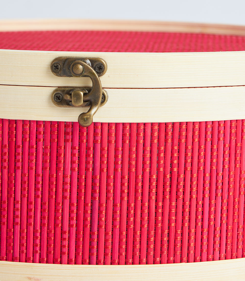 Red round woven gift basket with wooden lid and brass latch, perfect for luxury gifting