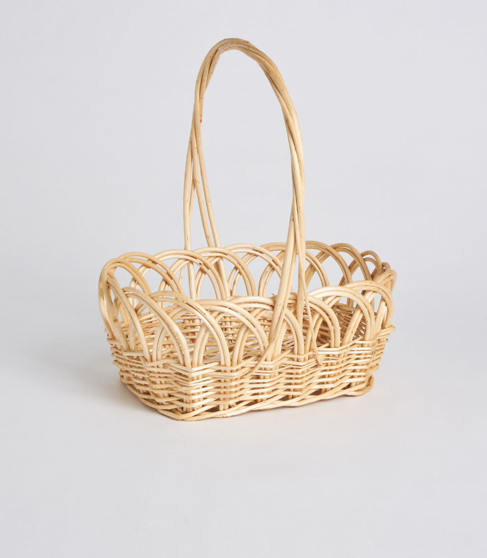 Natural wicker basket with arched handle and open-weave design, handwoven decorative oval gift basket