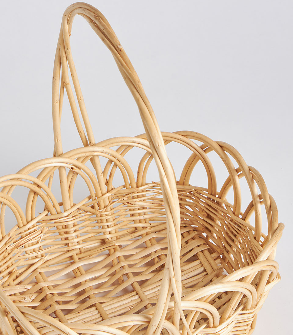 Light natural wicker oval basket with tall arched handle, handwoven rattan gift hamper