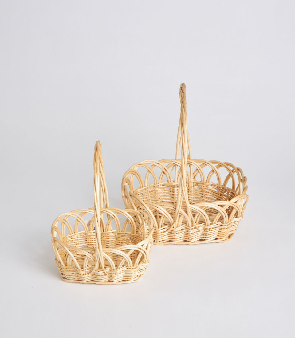Light natural wicker oval baskets with arched handles, handwoven artisan gift storage