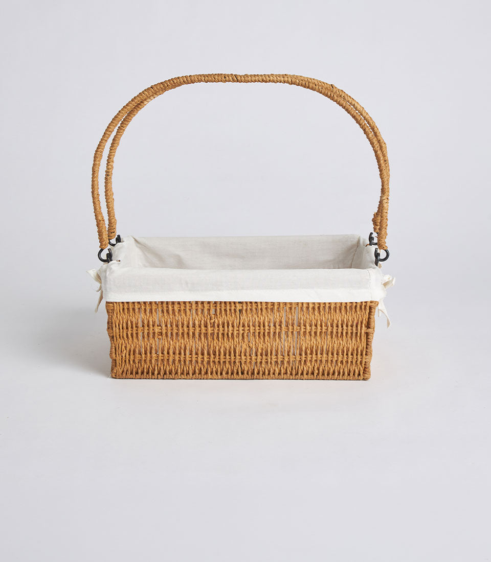 Handwoven rectangular wicker basket with dual handles and removable linen liner