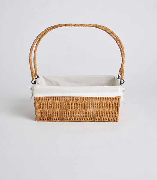 Handwoven rectangular wicker basket with dual handles and removable linen liner