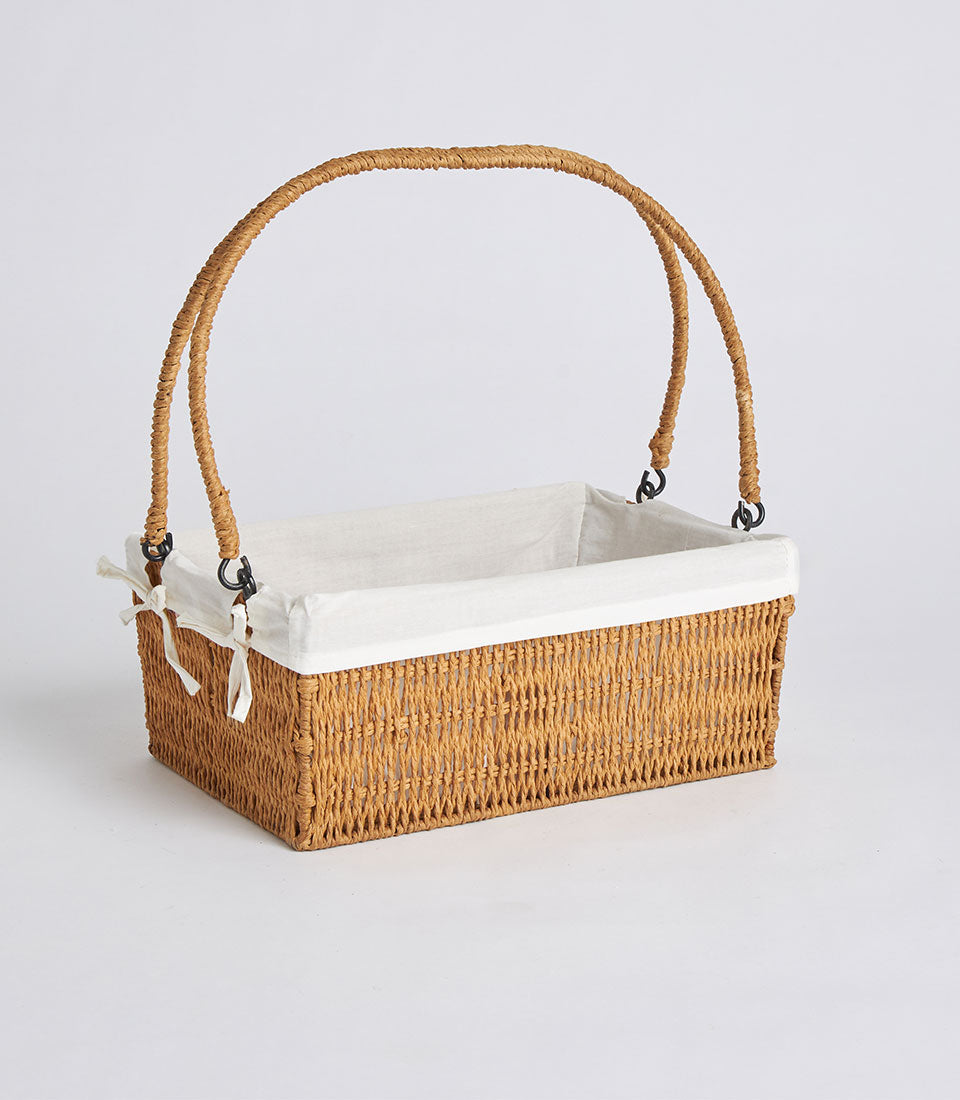 Handwoven rectangular wicker basket with cream linen liner and dual arched handles