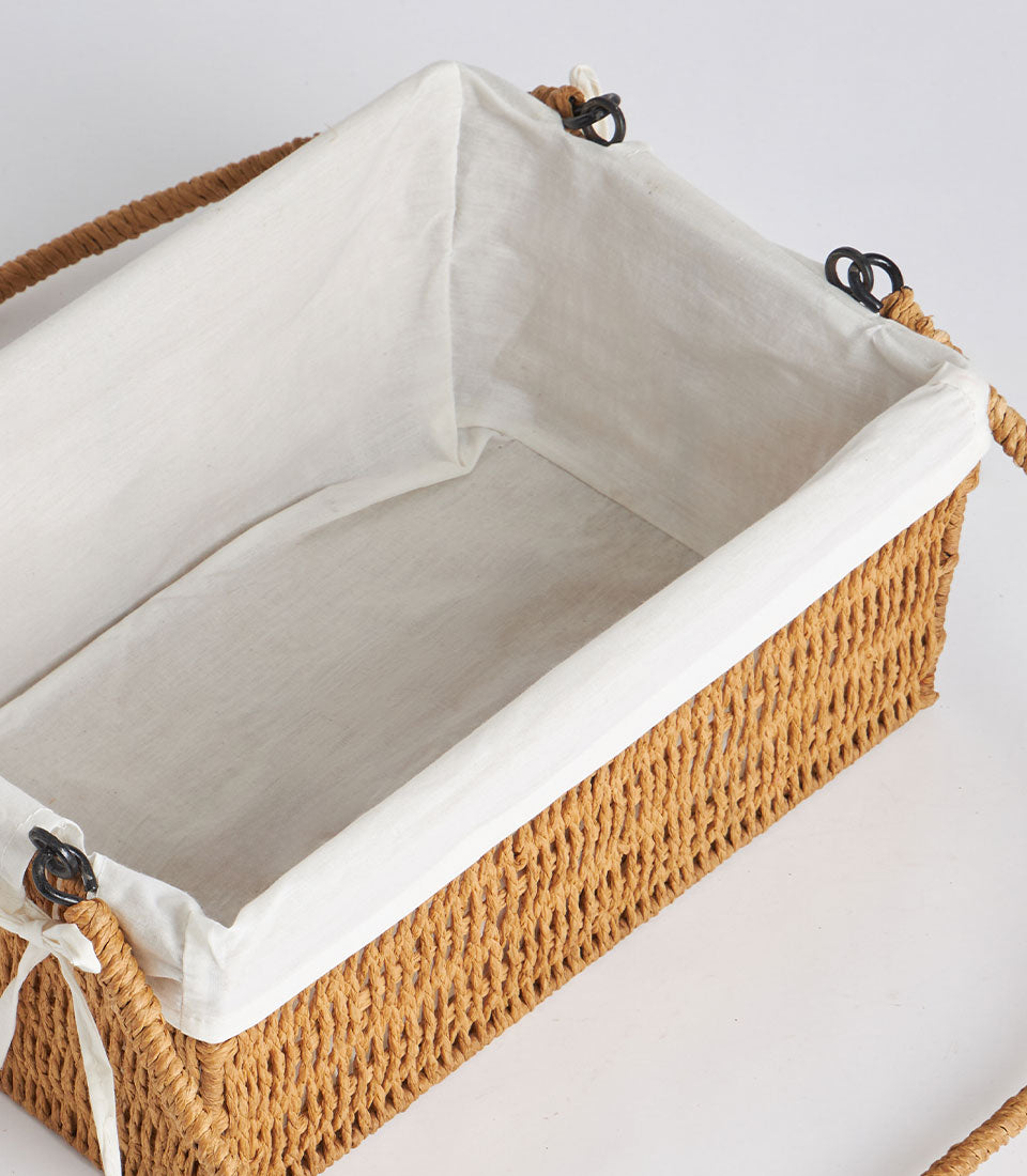 Handwoven rectangular wicker basket with white linen liner and dual braided handles