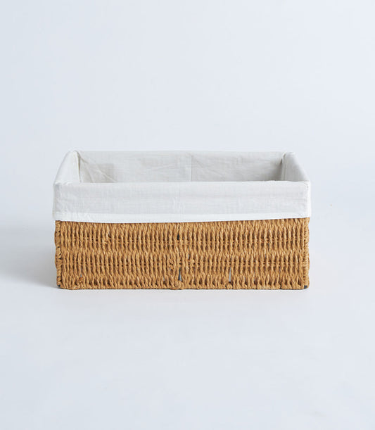 Handwoven rectangular wicker basket with natural fiber exterior and removable white fabric liner