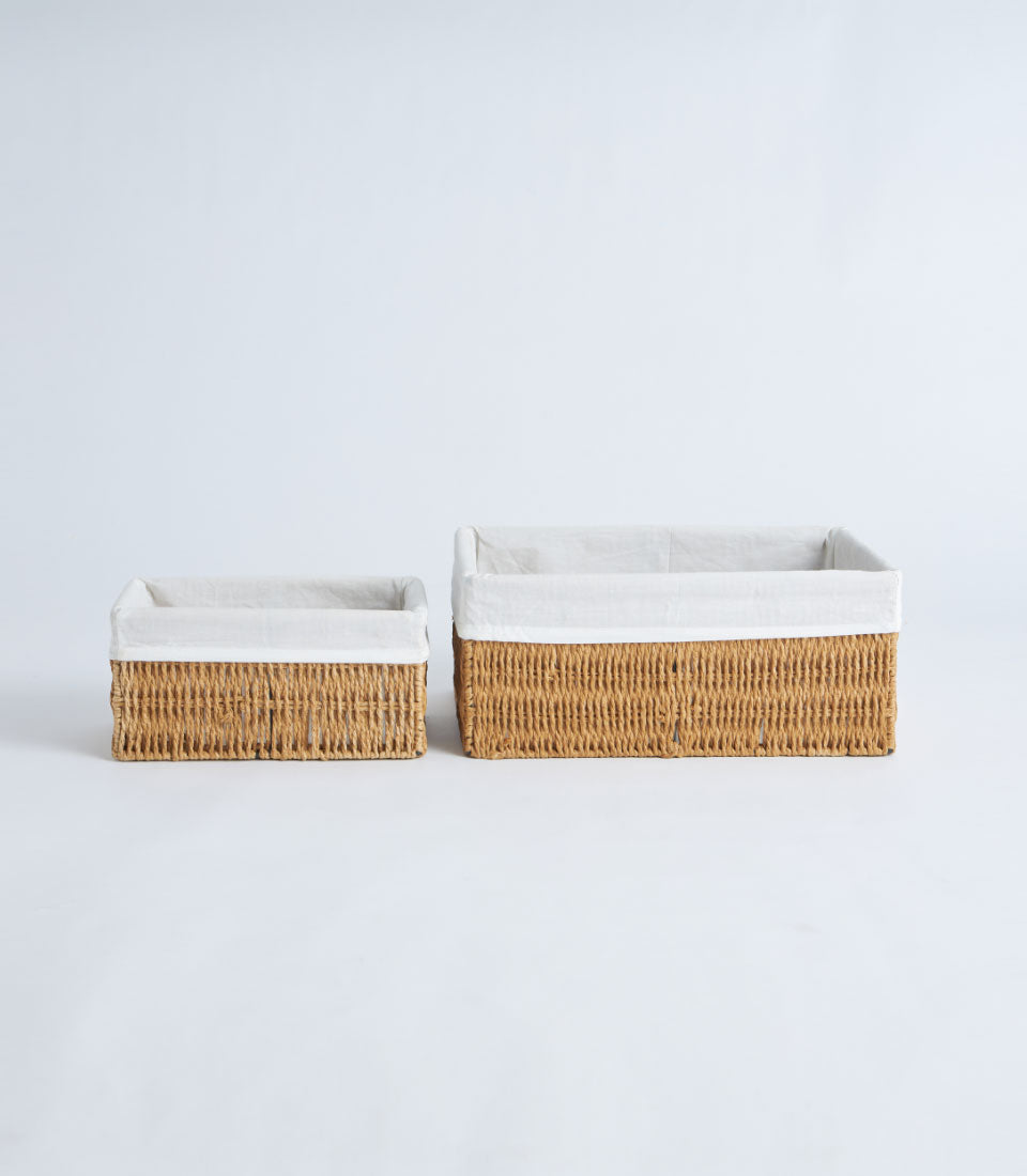 Handwoven wicker storage baskets with white fabric liners in natural tan, small and large sizes
