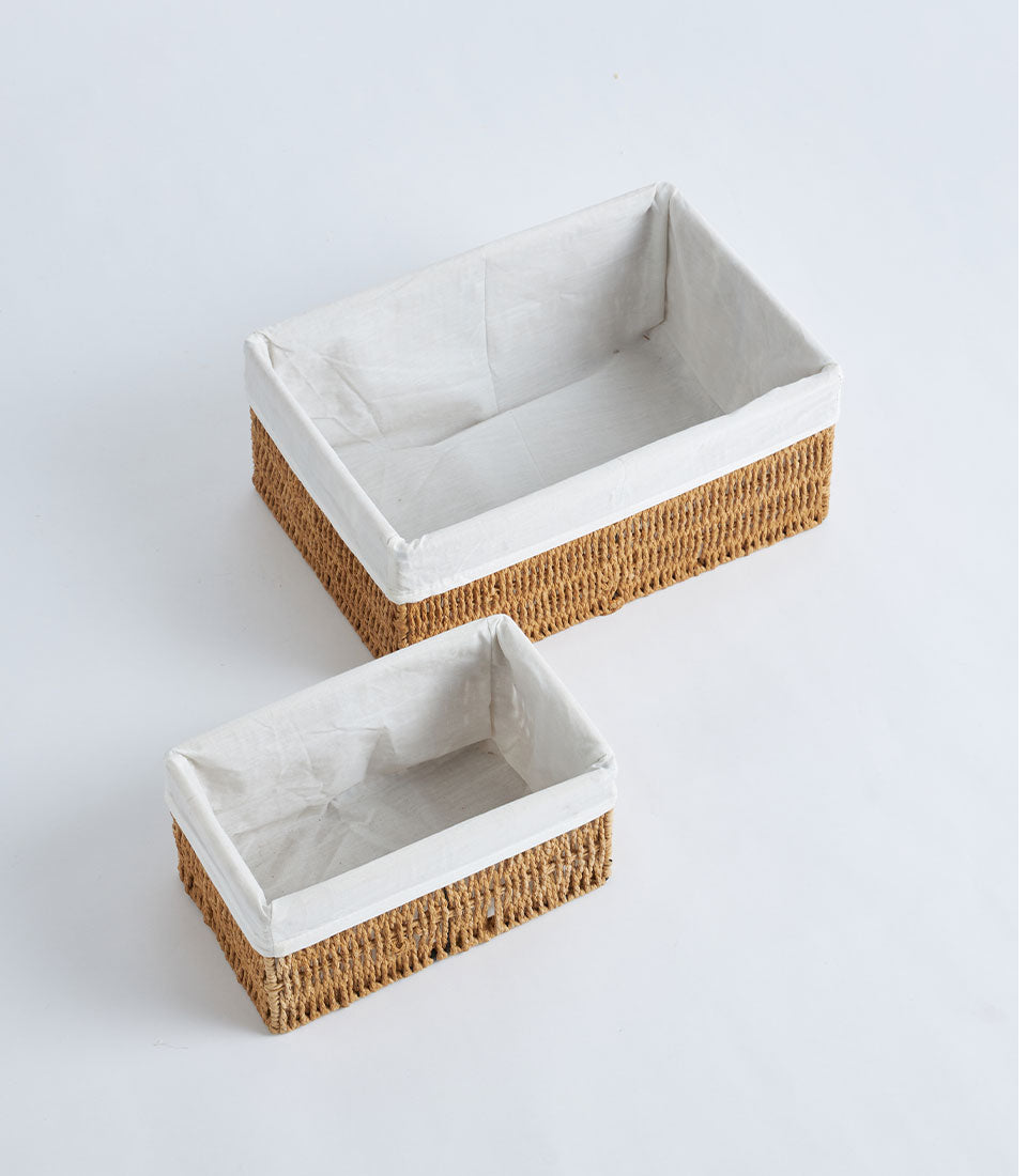Handwoven natural wicker storage baskets with white fabric liners in light brown rattan