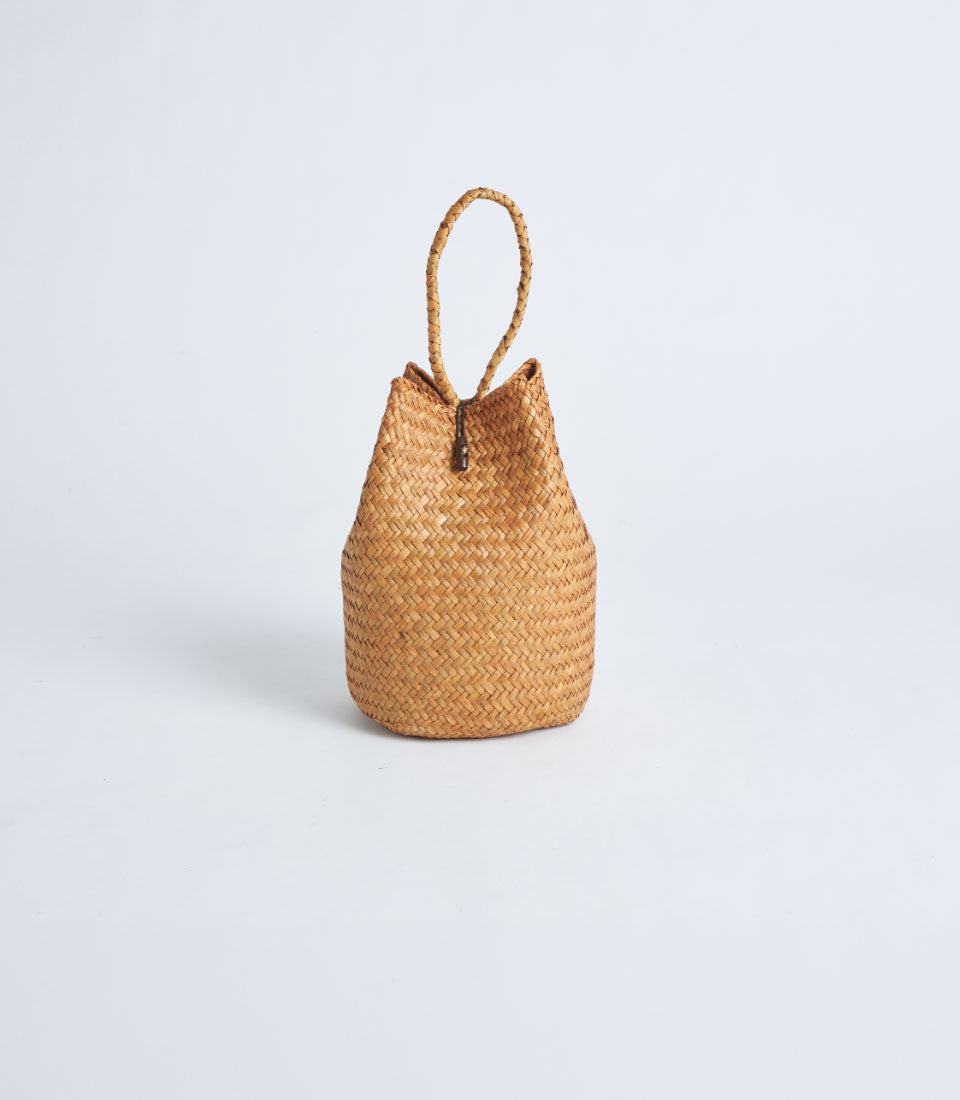 Light brown woven straw gift basket with rope handle and toggle closure