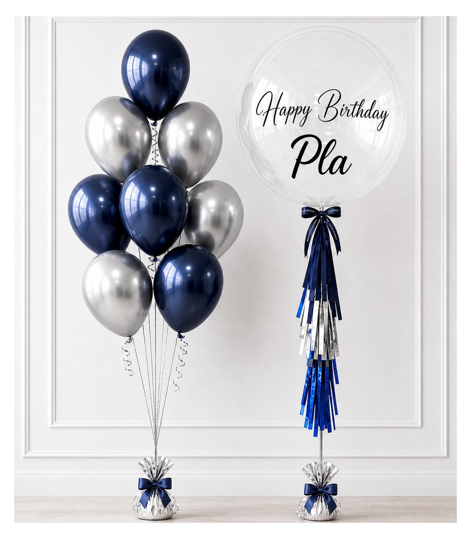 Navy and silver balloon bouquet with "Happy Birthday Pla" message on clear bubble balloon, elegant tassel decoration.
