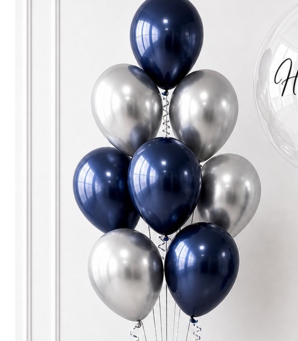 Elegant balloon bouquet featuring navy blue and silver metallic balloons arranged vertically with white ribbons against a light background.