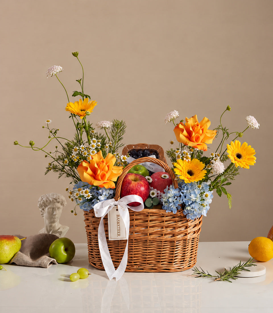 Basketeer luxury fruit and floral hamper with fresh apples, blueberries, and
