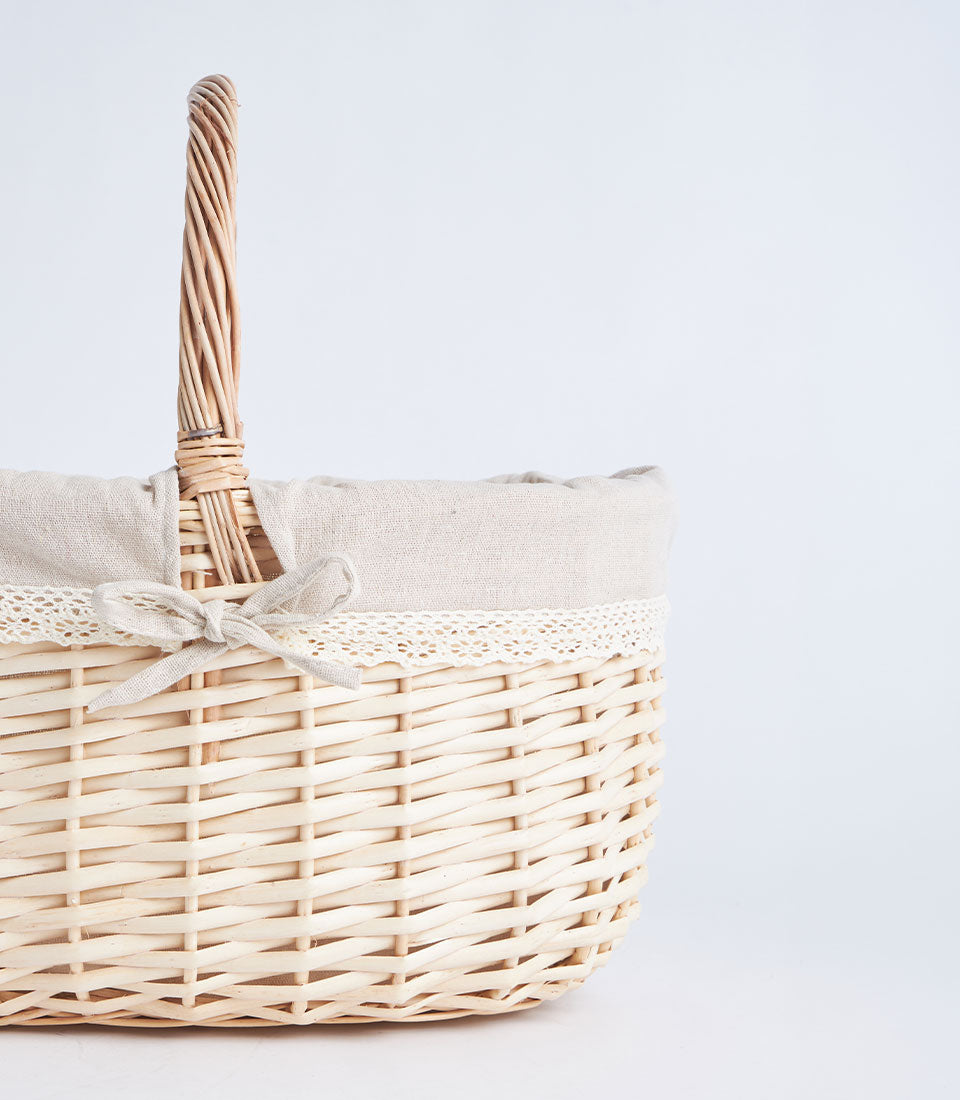 Handwoven light wicker basket with fabric liner and lace trim for fresh flowers and gifts